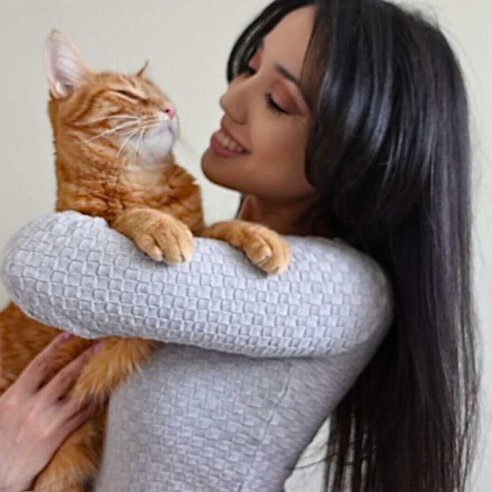 Veronica, Client Care Coordinator at Bothell Pet Hospital holding her cat.